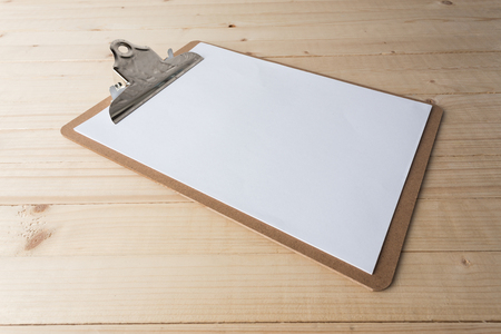 Wooden clipboard on wood backgroundの写真素材