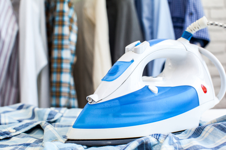 Electric iron and shirt, on cloth backgroundの写真素材