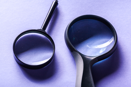 Magnifier on blue background close upの写真素材