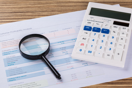 Calculator and magnifying glass on the table