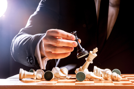 Hand of businessman playing chessの写真素材
