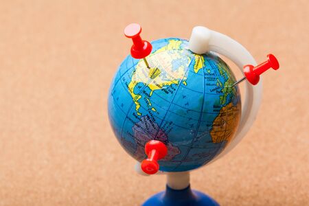 Travel destination points on a map indicated with colorful thumbtacksの写真素材