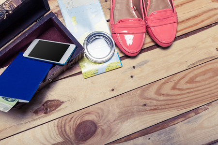 Accessories for travel. Passport, photo camera and travel map. Top view. Holidays and tourism conceptの写真素材