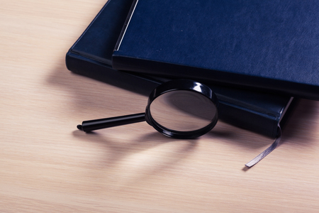 Notebook and magnifierの写真素材