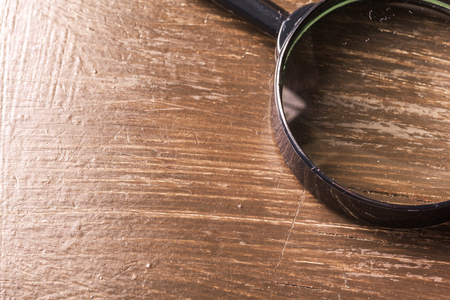 magnifying glass on the  wooden backgroundの写真素材