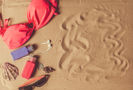 Holiday accessories on sand beachの写真素材