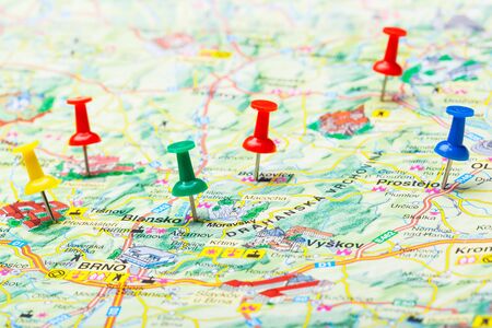 Travel destination points on a map indicated with colorful thumbtacksの写真素材