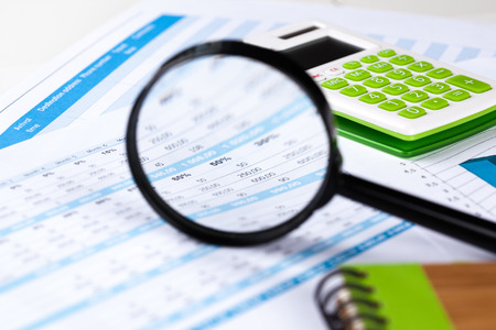 work with a magnifying glass, a calculator and papers