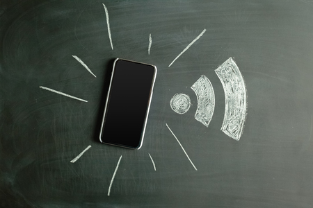 Wireless Symbol Drawn on a Blackboard near smartphone
