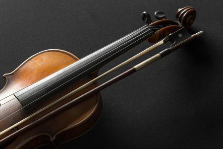 Old violin on a black backgroundの写真素材