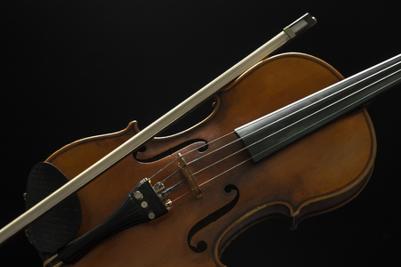 Old violin on a black backgroundの写真素材