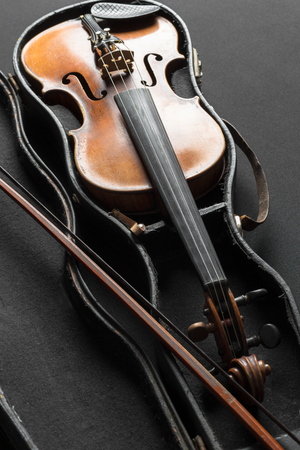 Old violin on a black backgroundの写真素材