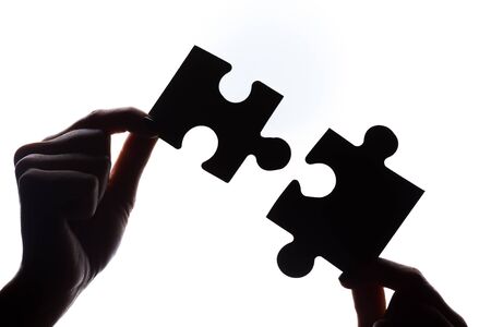 Hands holding puzzle pieces, business concept background