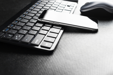 keyboard with mobile phone on the tableの写真素材