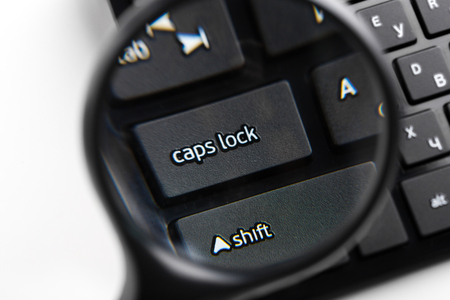 Magnifying Glass on black keyboardの写真素材