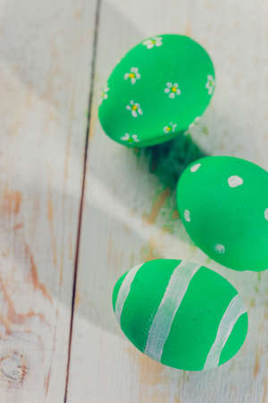 Easter eggs painted in pastel colors on white wooden background.の写真素材