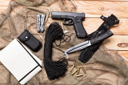 gun, knife with sheath, compass