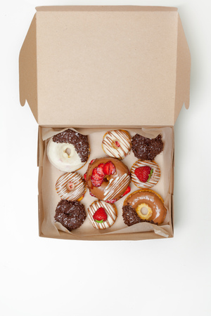 box of fresh donuts isolated on whiteの写真素材