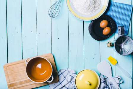 Preparation of the dough. Ingredients for the dough - Eggs and flour with a rolling pin. On wooden...