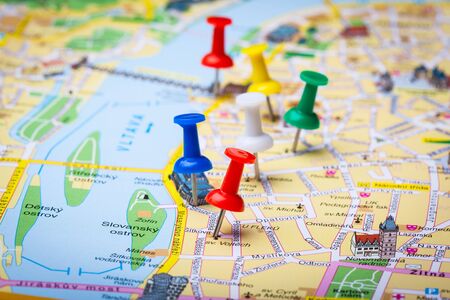 Travel destination points on a map indicated with colorful thumbtacks