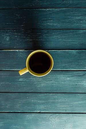 coffee mug on a dark wooden tableの写真素材