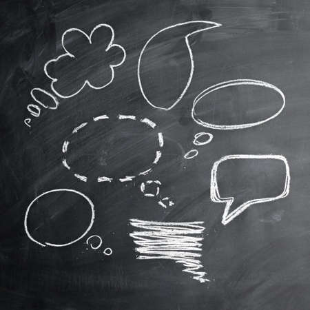 black board and white chalk speech bubbleの写真素材