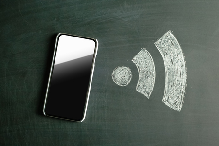 Wireless Symbol Drawn on a Blackboard near smartphoneの写真素材