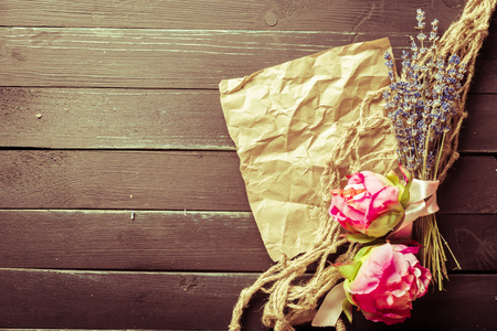 flowers and a notebook on wooden backgroundの写真素材