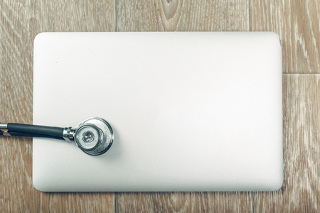 Stethoscope on laptop, close-upの写真素材
