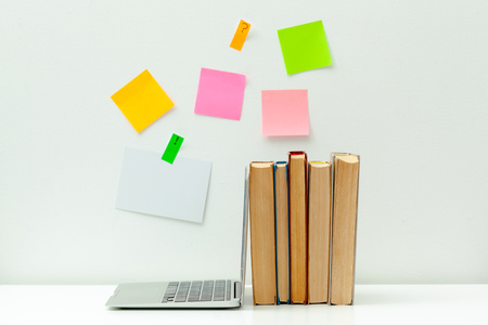 Working desk.Open laptop, books and other office supply
