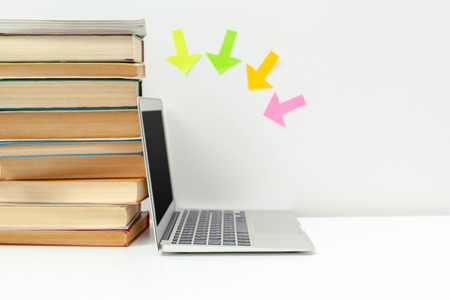 Working desk.Open laptop, books and other office supplyの写真素材