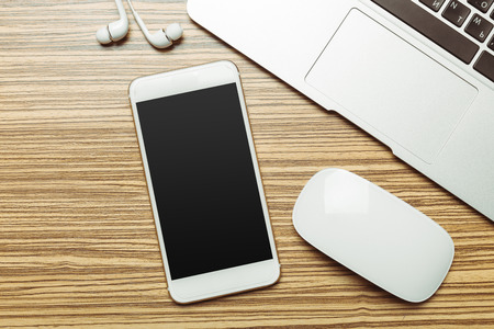 Office table with  smartphone on it. View from above
