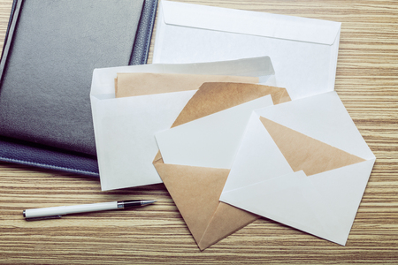 Photo of blank envelope on a  wooden backgroundの写真素材