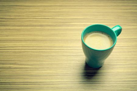 Cup of coffee on wooden table, top viewの写真素材