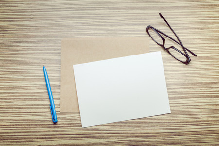 Photo of blank envelope on a  wooden backgroundの写真素材