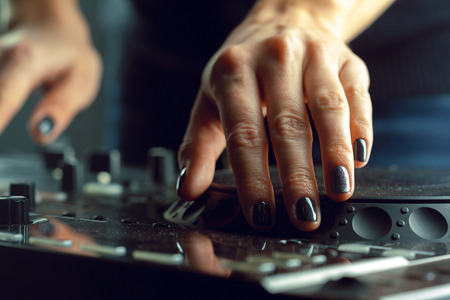 DJ playing music at mixer closeupの写真素材