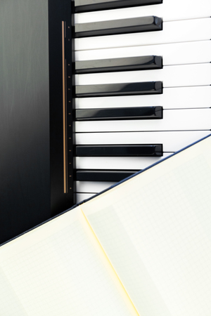 piano keys and notepadの写真素材