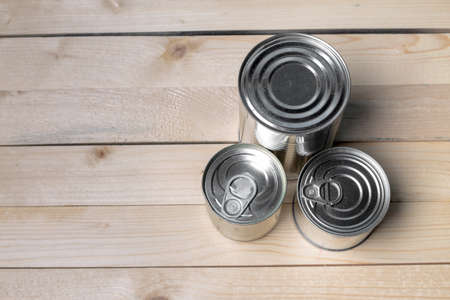 Tin cans for food on wooden backgroundの写真素材