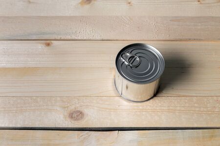 Tin cans for food on wooden backgroundの写真素材