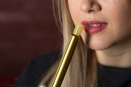 Young, beautiful girl smokes a hookah