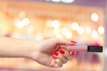 Woman's hand holds lipstickの写真素材