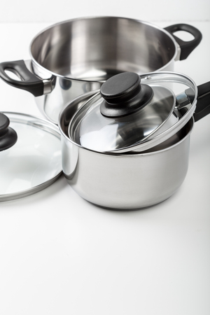 Stainless steel pots and pans isolated on whiteの写真素材