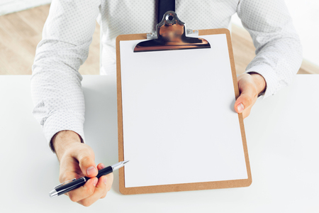 Clipboard on a white table. close upの写真素材