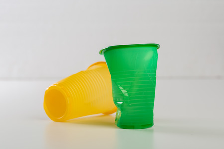 Multicolor disposable plastic glasses isolated on white backgroundの写真素材