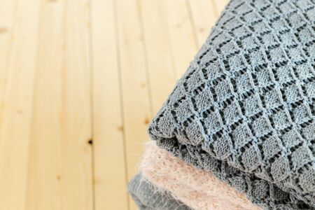 Stack of white cozy knitted sweatersの写真素材