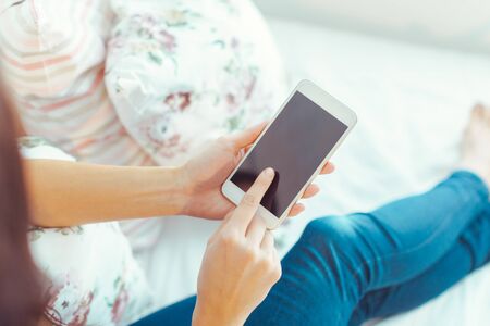 Woman with modern mobile phone in handsの写真素材