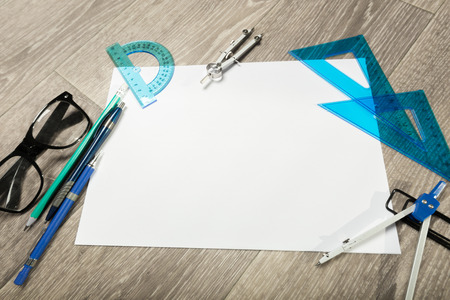 Blank notebook and pencil with glasses on wooden tableの写真素材