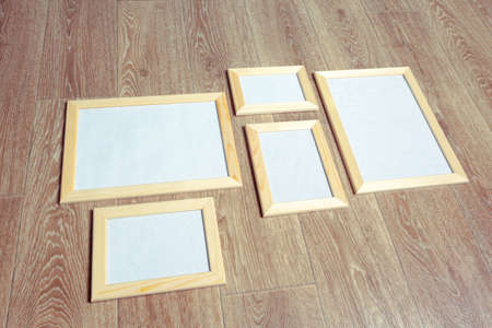 photo frames on the wooden wall