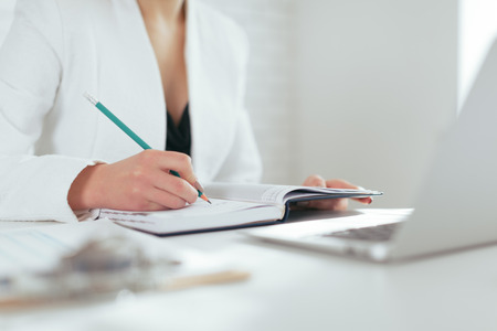 Portrait of beautiful young woman working in the office.の写真素材