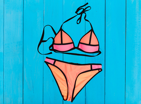 swimsuit on wooden background. top viewの写真素材